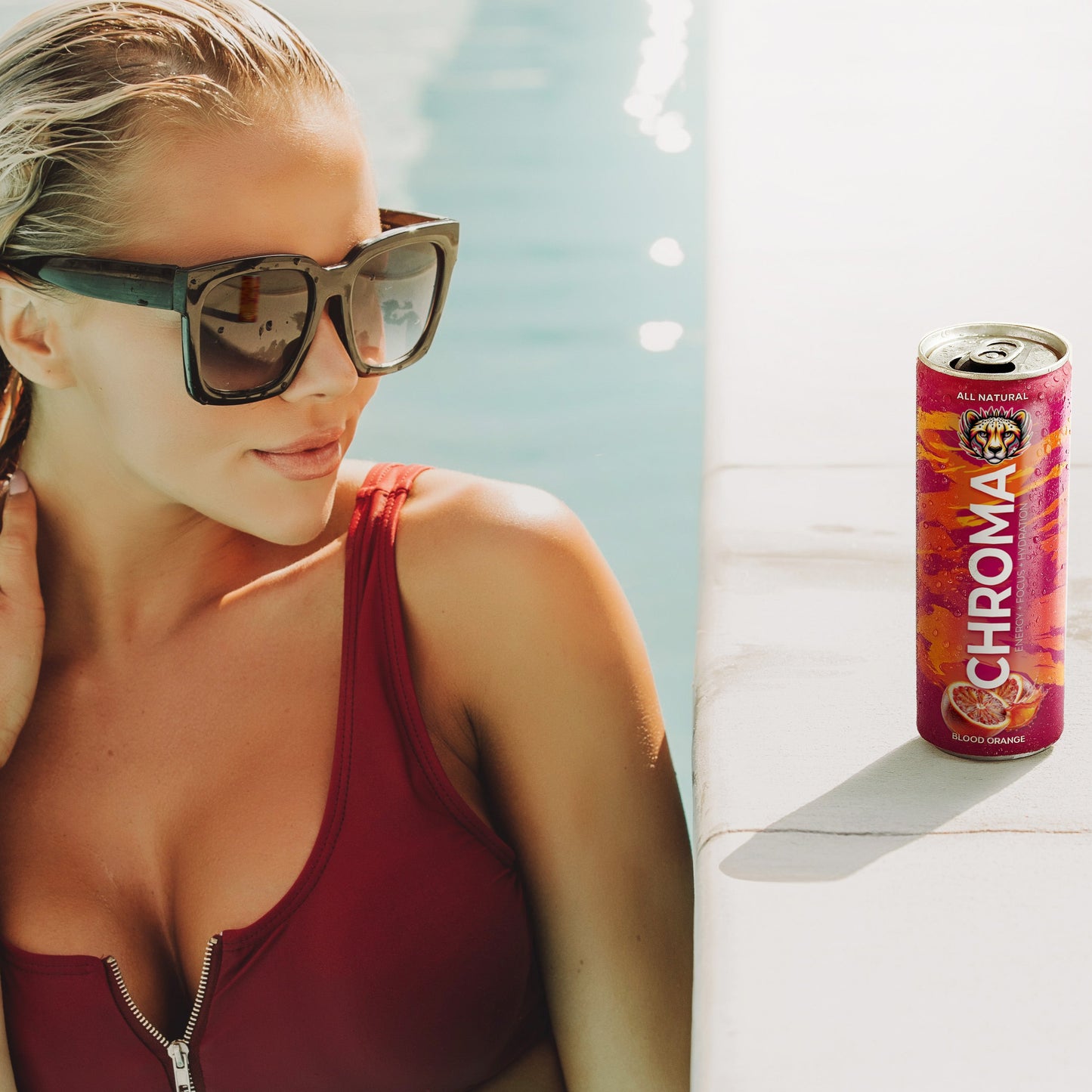 blonde in pool with Chroma clean energy drink for focus and no crash – Blood Orange can